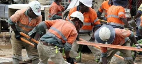 Construction crew working on site in protective equipment