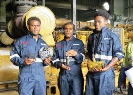 Field team in workshop coveralls holding equipment